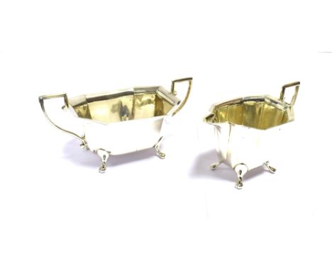 ART DECO SILVER TEA SERVICE  To include a teapot standing 15cm tall, sucrier and cream jug, of geometric form on pad feet.  H
