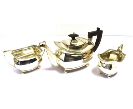ART DECO SILVER TEA SERVICE  Of geometric form with gadrooned edges and classical handles on orb feet, to include a teapot st