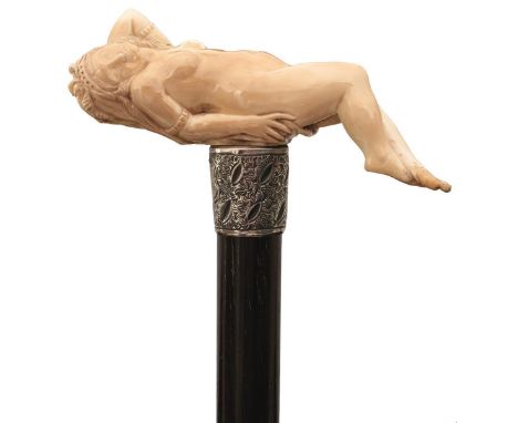 A LATE VICTORIAN WALKING STICK, the handle carved as a reclining nude female, engraved silver collar with vacant cartouche ha