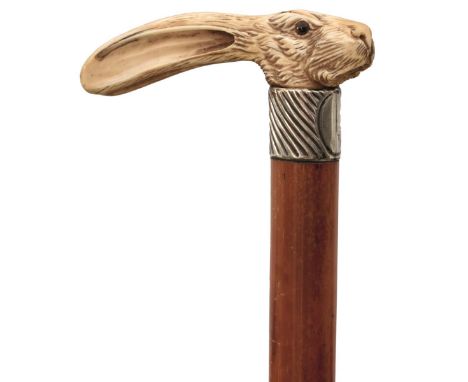 A LATE 19TH CENTURY SWORD STICK, the ivory handle carved as a hare's head with glass eyes, silver collar, malacca haft contai