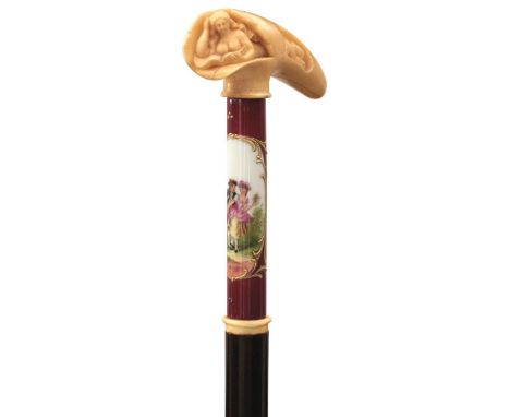 A 19TH CENTURY WALKING STICK OF SLENDER PROPORTIONS, the ivory handle carved as a naked lady reading a book, Sevres style por