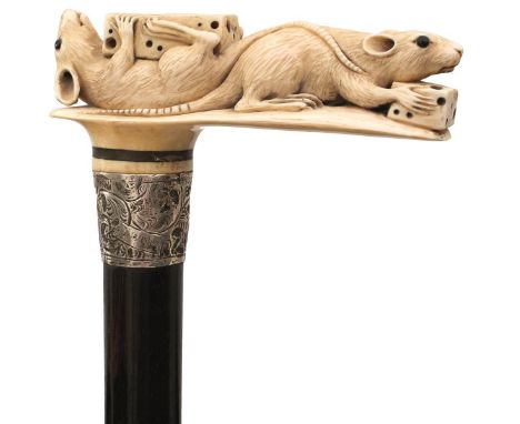 A LATE 19TH CENTURY WALKING STICK, the ivory handle carved as two rats or mice eating cheese, foliate engraved silver collar 