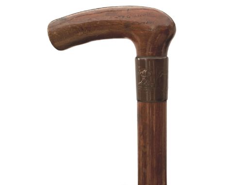 A LATE 19TH/EARLY 20TH CENTURY WALKING STICK OF NELSON INTEREST, of oak and with embossed copper collar, the oak and copper t