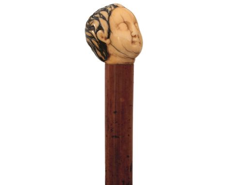 A LATE 19TH CENTURY SWORD STICK, the ivory pommel carved as "The Good Shepherd" (possibly Goanese), the haft containing 69.5c