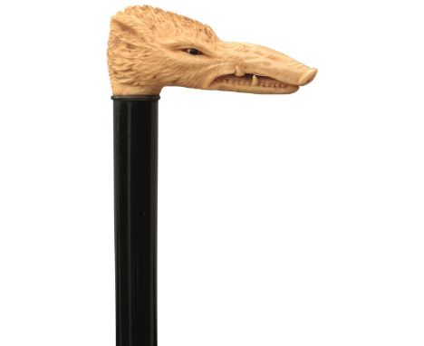 A LATE 19TH/EARLY 20TH CENTURY WALKING STICK, the carved ivory handle in the form of a boar's head with glass eyes, ebony haf