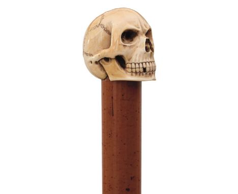 A LATE 19TH CENTURY SWORD STICK, the ivory pommel carved as a skull, malacca haft incorporating 65.5cm fullered tapering blad