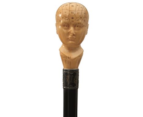 A VICTORIAN WALKING STICK, the ivory handle carved and etched in the form of a Phrenology head, above embossed white metal co