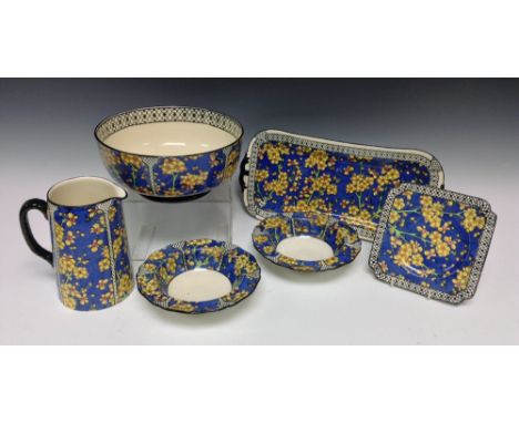 A Royal Doulton Prunus pattern part breakfast service, D1365, comprising a circular footed bowl, shaped rectangular tray, a t