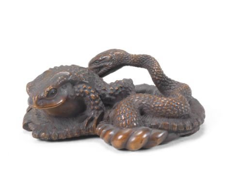 A large boxwood netsuke of a toad and snakeBy Masanao, Ise, Yamada, Edo period (1615-1868), mid-19th centuryThe unsuspecting 