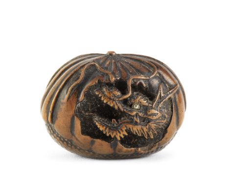 A wood netsuke of a dragon in a chestnutBy Toyoyasu (Toyoyo), Edo period (1615-1868), Sasayama, Tanba Province, 19th centuryT