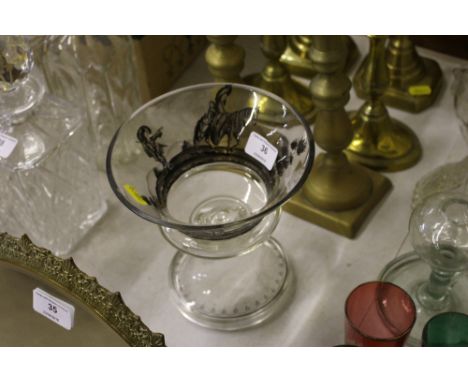 A glass pedestal vase with black enamel decoration depicting figures on horse back 