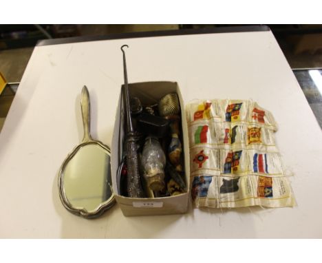 A box containing a pine enamel decorated hand mirror, a silver pistol grip button hook, various pens etc. 