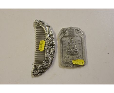 An oriental comb and an oriental white metal tablet