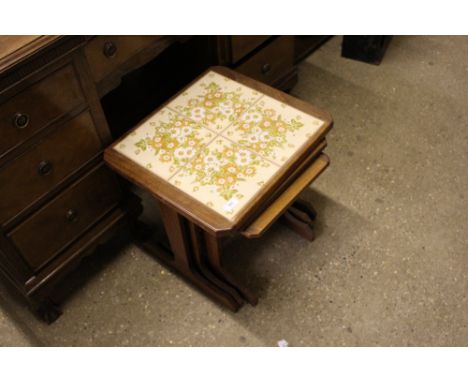 A nest of three teak and tile top occasional tables