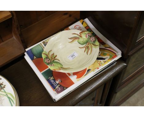 A Royal Staffordshire dish by Clarice Cliff; together with a quantity of Clarice Cliff related magazines 