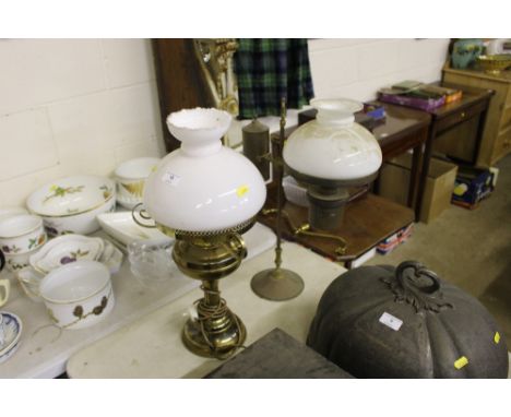 A brass oil lamp with milk glass shade converted to electricity; together with a brass students lamp 