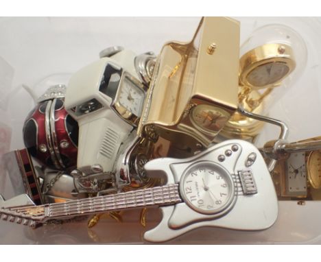 Nine miniature quartz clocks and a mini harmonica 