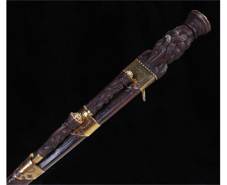 Scottish Dirk with celtic knot grip contained in a brass mounted leather scabbard with knife and fork in the usual position r