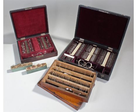 Early 20th Century opticians set, with cased lenses and glasses, together with another set, a lens set and two card boxes of 