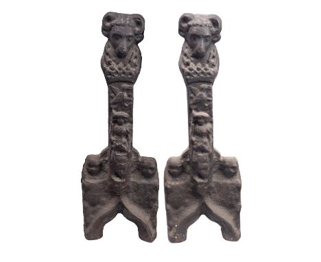 A pair of substantial cast iron andiron fronts in 17th century taste, 19th century; with aegicranial finials, the shafts with