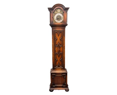 An oak cased chiming miniature longcase clock having an eight-day duration movement striking the hours and chiming the quarte