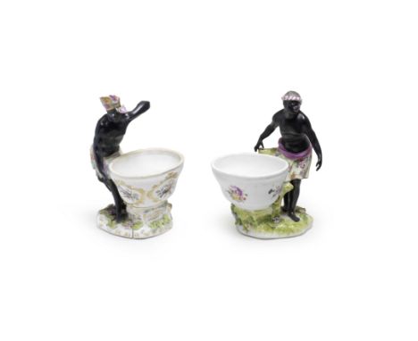 Two Meissen figural salts, circa 1765, one later-decoratedThe first wearing a purple-striped headscarf and puce-lined yellow 