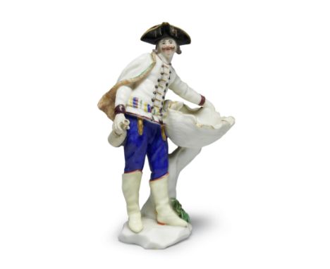 A Capodimonte figure of a Hussar, circa 1750Modelled by Giuseppe Gricci, wearing a black hat, a jacket with cape and sash, bl
