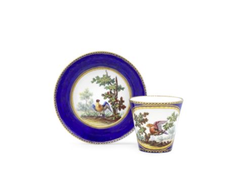 A Sèvres blue-ground cup and saucer (gobelet à la Reine et soucoupe), dated 1763The bleu-lapis ground reserved with gilt-edge