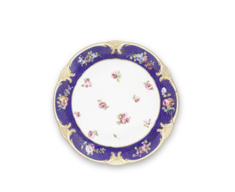 A Sèvres blue-ground plate (Assiette à palmes), circa 1769Painted by J-J. Pierre (le jeune) with scattered roses in the well,