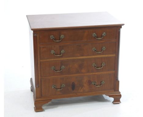 A Georgian style mahogany chest of drawers
With a rectangular moulded top above four cockbeaded graduated long drawers each w
