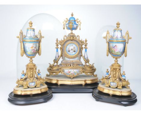 A late 19th Century gilt metal and Sevres style clock garniture
The central clock, with upper urn finial, extending to an arc