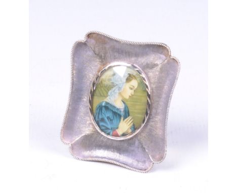 A Continental silver frame and music box of rectangular form
with canted corners, an applied twist border and profusely chase
