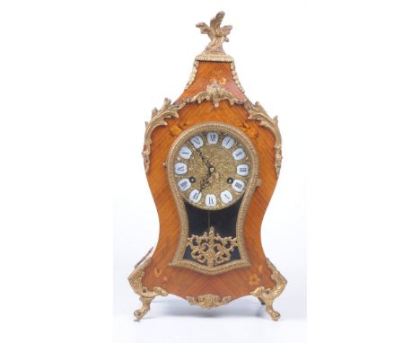 A 20th Century Italian marquetry effect balloon mantel clock
Of typical rounded form, applied with swept foliage brass mounts