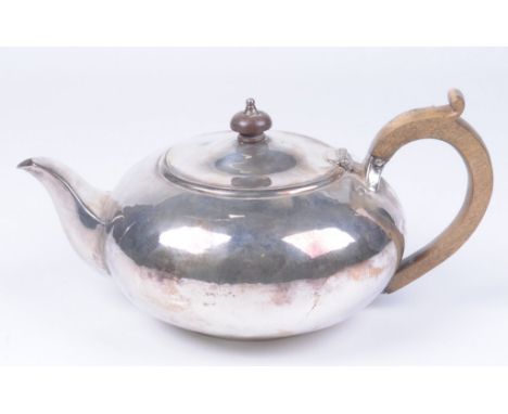 A Victorian silver presentation teapot
Of squat circular form plain oval form, monogrammed to one side, with a turned wooden 