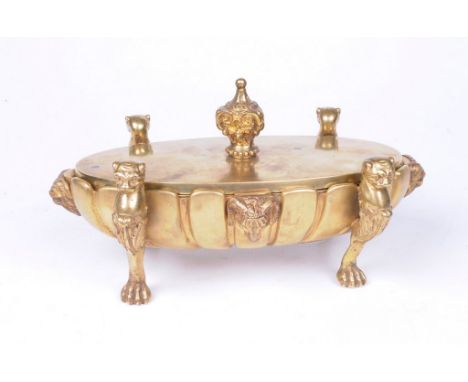 A Victorian gilt metal desk stand
The oval and fluted stand, raised on four lion supports and flanked with bejewelled elephan