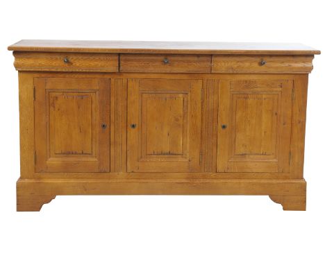 A Golden oak country French style sideboard,
with a rectangular moulded top above three frieze drawers each with metal button