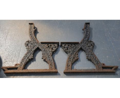 A pair of Victorian black painted cast iron bench ends
The arched back with shallow seat, supported on twin supports and base