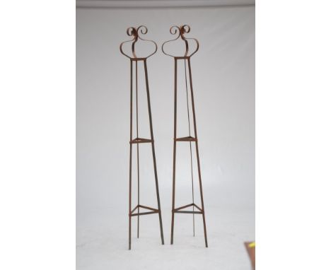 A pair of wrought iron garden obelisks
Each of tapered triform, with bracket central sections, terminating at a scroll top, w