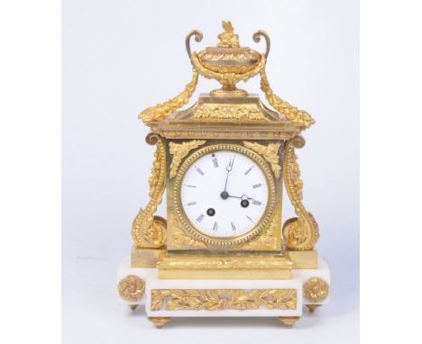 A French gilt metal and alabaster mantel clock, Circa 1900
The polished gilt metal case, surmounted by an urn finial, extendi