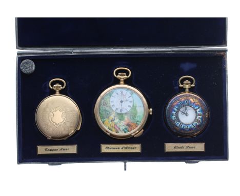 Three erotic gold plated pocket watches displayed within a pewter hinged case and labelled 'Tempus Amor', 'Chanson d'Amour', 