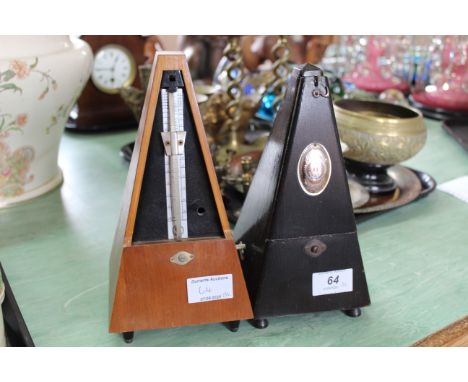 A German made metronome by Maelzel plus a lightwood German metronome (lacking front cover)