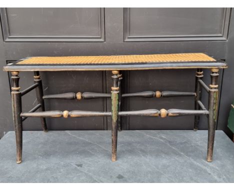 An ebonized, polychrome painted and cane long stool or window seat, 91cm wide.&nbsp; 