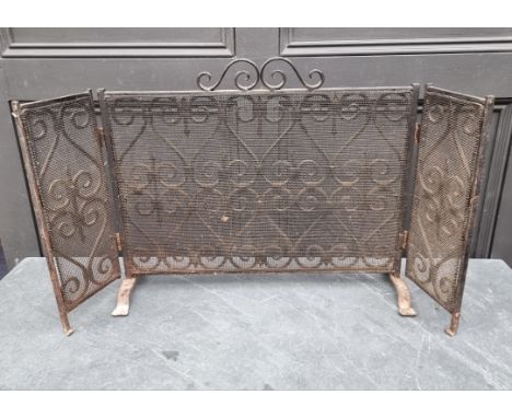 An old wrought iron triptych fire screen, 92.5cm wide. 