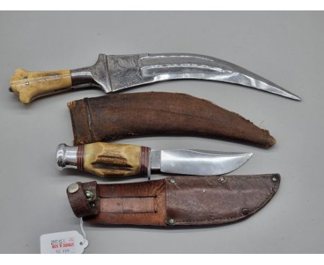 An Arab jambiya and sheath, with 20cm blade and bone scales; together with a vintage antler handled knife and leather sheath,