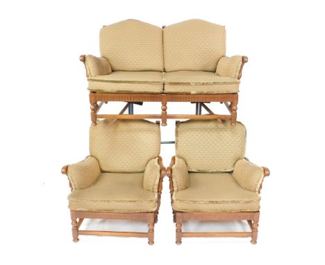 An Ercol Colonial oak three piece cottage suite, comprising two seater sofa, 84cm x 152cm x 81cm, and a pair of armchairs.