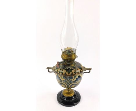 A Doulton Lambeth late 19thC stoneware oil lamp, sgraffito decorated with stylised flowers and leaves, with Young's Special b
