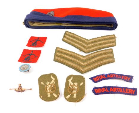 A 9ct gold and enamel Royal Artillery bar brooch, 4.0g, a Royal Artillery Field Service cap, Sergeant's stripes, and badges, 