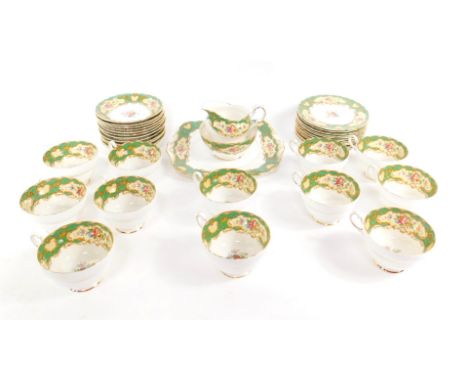 A Paragon porcelain tea service decorated in the Pompadour pattern, comprising bread plate, cream jug, sugar bowl, twelve cup