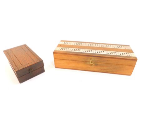 An early 20thC oak cribbage box, 15cm L, and a further cribbage box, containing playing cards, 25.5cm L. (2)