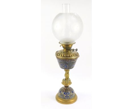 A Doulton Lambeth late 19thC stoneware and brass oil lamp, with sgraffito stylised floral motifs, with chimney, and frosted g